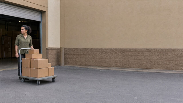 Staff member with delivery boxes at back door