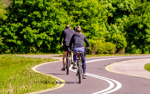 Cyclists ride on the bike path in the city Park
