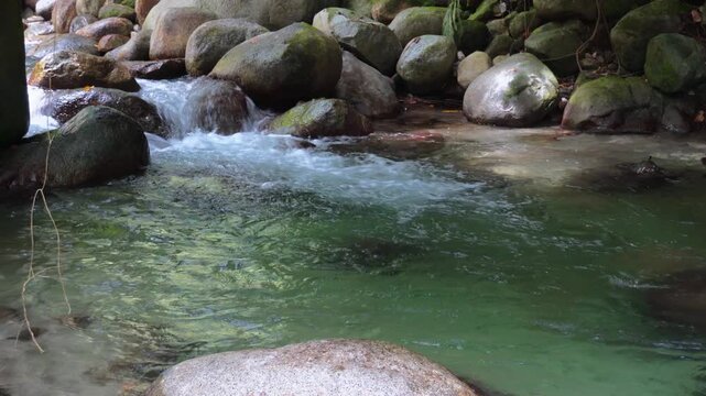 Emerald Natural Pool Between Tropical River Rocks 4K