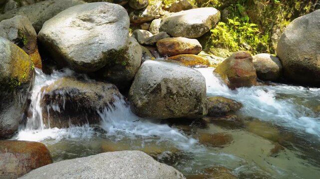 Clear River Water Flowing Around Giant Tropical Rocks 4K