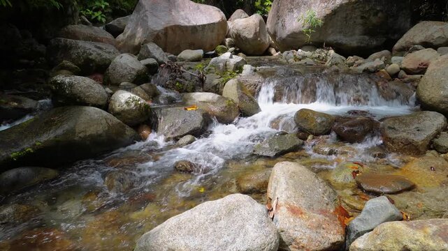 Small Rocky Waterfall in Tropical Rainforest Stream in indonesia 4K