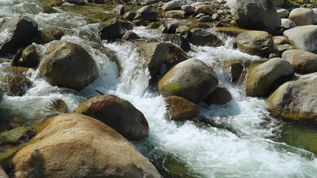 Clear Tropical River Flowing Between Large Granite Rocks in indonesia