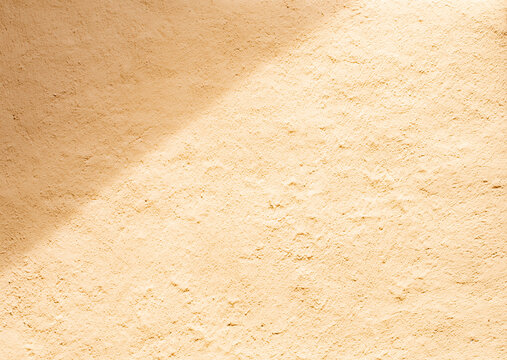 Soil wall texture of clay house structure with sunlight. Mud background