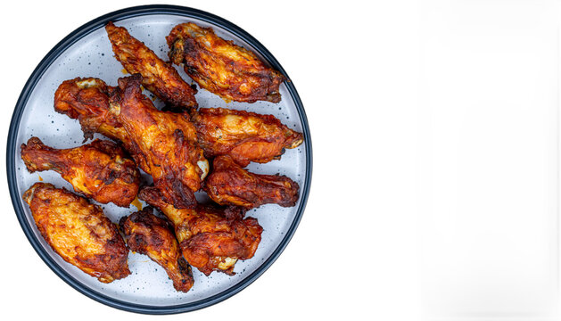 Crispy baked chicken wings on a plate with copy space