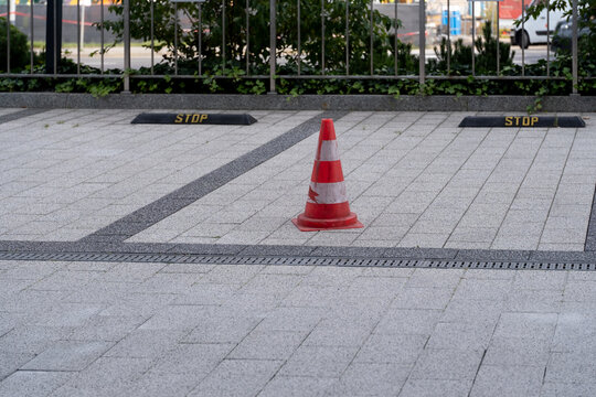 Traffic cone and parking stops on paved parking area
