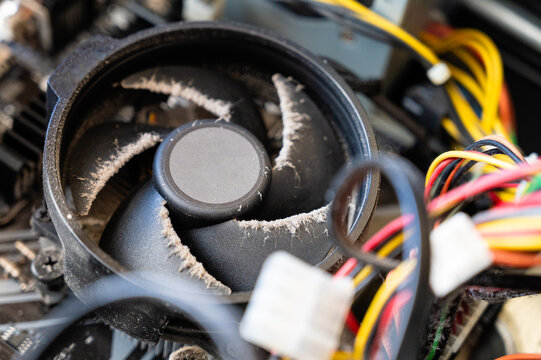 Macro view of a dirty black computer cooling fan with dust
