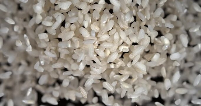Rice grains falling in slow motion rustic texture top view