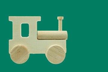Wooden toy train engine on green background © Floren Horcajo