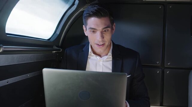 Amazed young businessman flying on a fast rocket looking at his laptop monitor. Global network speed concept. Business success and high targets.