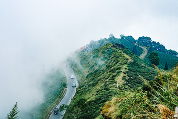Scenic hill station landscape in India with green mountains, misty valleys and forest. Beautiful Himalayan scenery, ideal for travel, tourism, nature and holiday destination themes. © Sanket Mishra