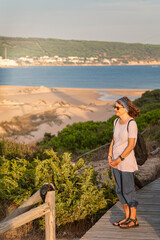 Senior woman enjoying coastal view on wooden boardwalk in Cadiz © Paolo Corazza