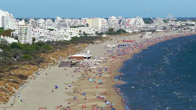 Aerial view of people swimming and relaxing on the beach in La Grande-Motte, H&eacute;rault, South of France