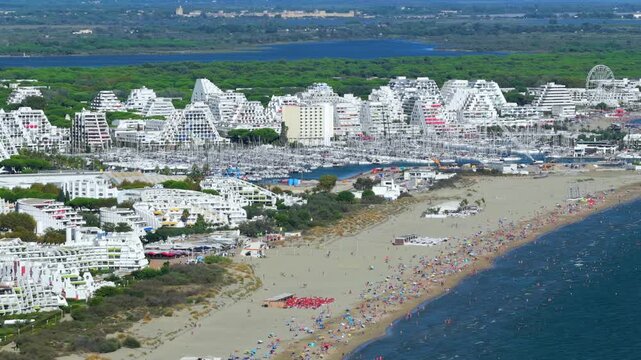 Aerial view of people swimming and relaxing on the beach in La Grande-Motte, H&eacute;rault, South of France