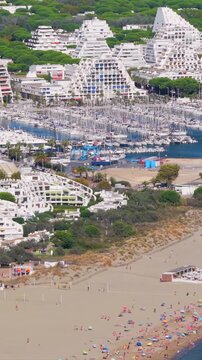 Aerial view of people swimming and relaxing on the beach in La Grande-Motte, H&eacute;rault, South of France