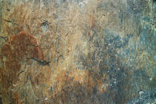 Abstract nature background of a weathered ancient rock surface with rust details