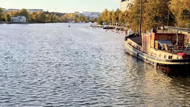 Moored Boat Along a Calm Helsinki City Canal in Autumn Light
