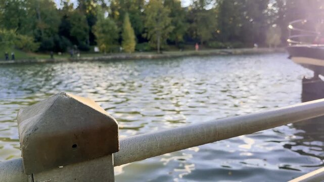 Railing Post in Focus With a Stone Bridge Behind