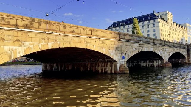 Stone Bridge Arches Reflected in a Calm Helsinki City River