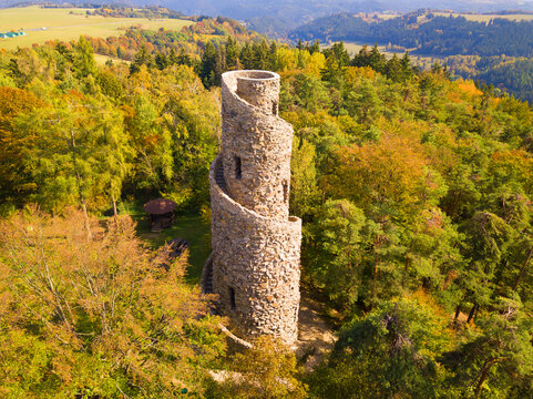 Aerial view of stone observation tower in Krasno inside forest Slavkovsky les. Beautiful tourist landmark and nature landscape from drone view. West Bohemia in Czech republic, EU.