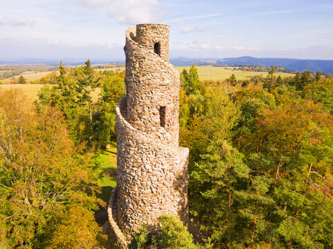 Aerial view of stone observation tower in Krasno inside forest Slavkovsky les. Beautiful tourist landmark and nature landscape from drone view. West Bohemia in Czech republic, EU.