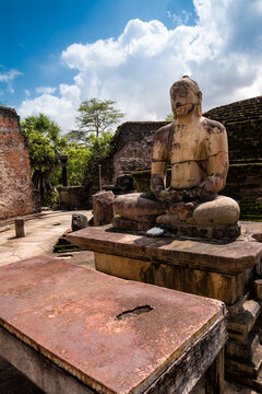 Ancient Buddha Statue in Polonnaruwa with Crumbling Brick Ruins