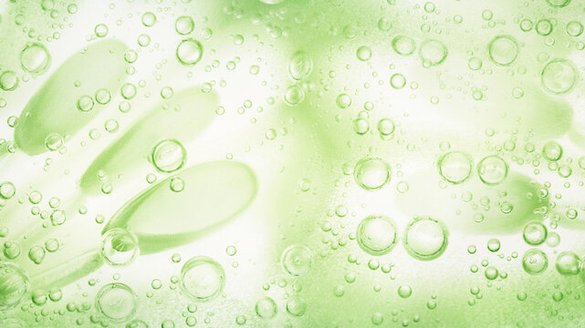 Green cosmetic gel macro texture background with oxygen bubbles