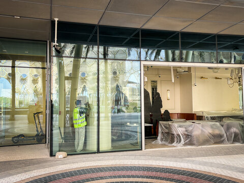 Empty retail unit waiting behind glass at a former exhibition site in Dubai, United Arab Emirates