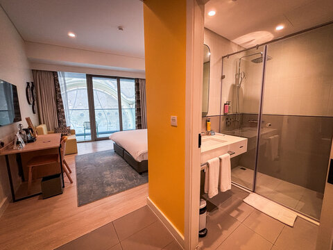 Hotel room opening onto its glass bathroom at a former exhibition site in Dubai, United Arab Emirates