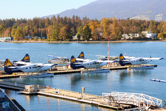 Vancouver, Canada- October 12, 2022: Harbour Air seaplanes docked at Vancouver Harbour Flight Centre in Coal Harbour within Burrard Inlet