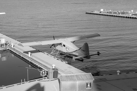 Vancouver, Canada- October 12, 2022: C-FHRT registration seaplane of De Havilland Canada DHC-2 Beaver type by  Gulf Island Seaplanes docked at Vancouver Harbour Flight Centre in Coal Harbour