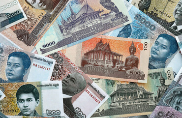Cambodian riel money banknotes pile on table. Cambodia bills of KHR currency close up © Larysa