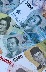 Indonesian rupiah money banknotes bunch on table. Indonesia bills of IDR currency close up © Larysa