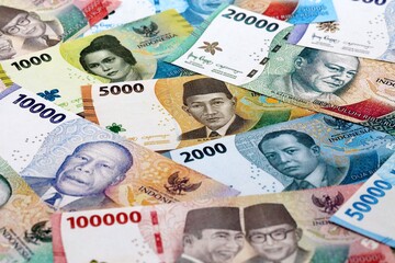 Indonesian rupiah money banknotes pile on table. Indonesia bills of IDR currency close up © Larysa