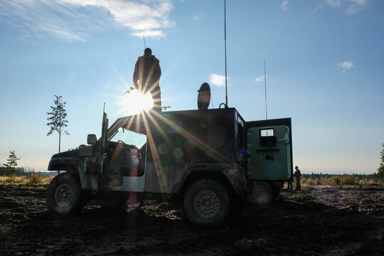Sun setting behind a French army command vehicle during a multinational deployment near Tapa, Estonia