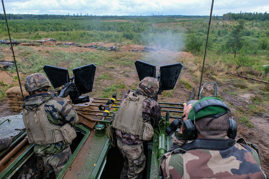 French soldier firing from the top of an armoured vehicle during a multinational deployment exercise near Tapa, Estonia