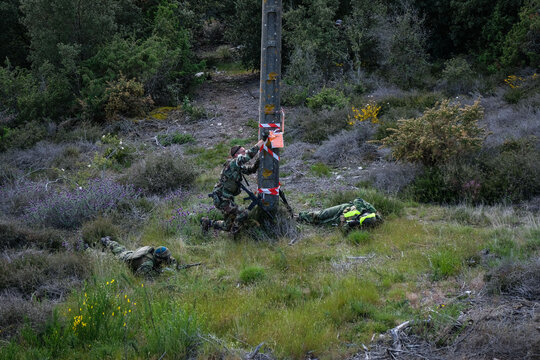 Teammate bandaging a hit airsoft player during a twenty four hour war game near Carcassonne, France