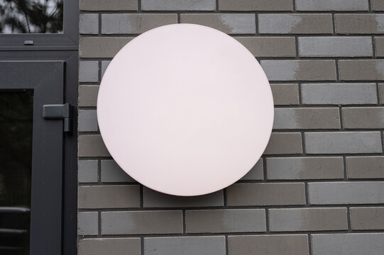 Mockup Round blank signboard on gray brick wall empty illuminated circle for logo advertising branding or text