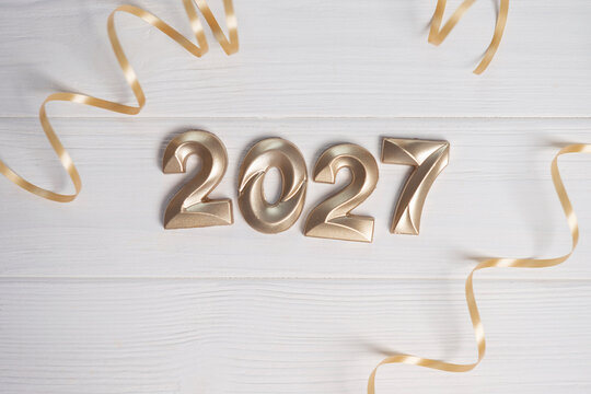 Golden numbers 2027 and decorative ribbons creating a cheerful festive atmosphere for upcoming events