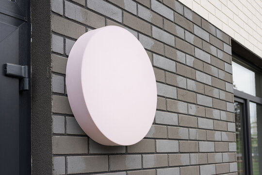 Round blank signboard mockup on gray brick wall empty illuminated circle for logo branding or text advertising