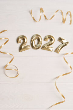 Golden numbers 2027 and decorative ribbons creating a cheerful festive for atmosphere events upcoming