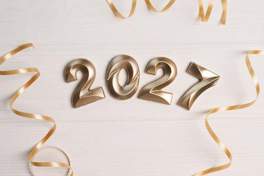 Golden numbers 2027 and decorative ribbons creating a cheerful festive upcoming events atmosphere
