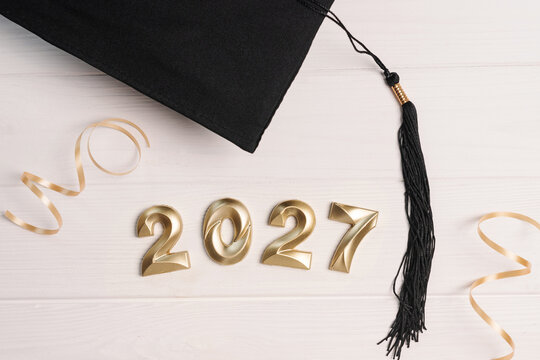 Graduation cap with 2027 numbers and golden ribbon symbolizing academic achievement and future success