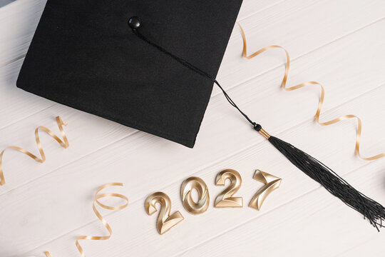 Graduation cap with 2027 numbers and golden ribbon symbolizing academic and future success achievement