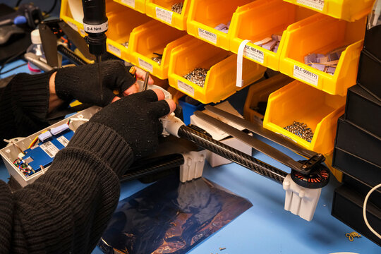 Picking components from storage bins in the workshop of a military drone manufacturer in Toulouse, France