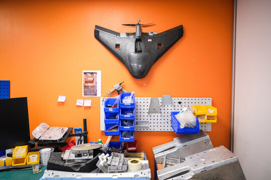 Black flying wing drone hung on the workshop wall of a military drone manufacturer in Toulouse, France