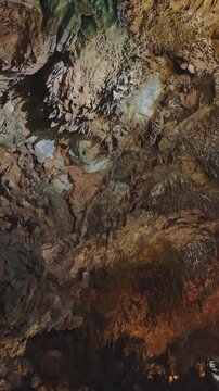 Deep cavern interior showing amazing stalactites and stalagmites. Natural rock formations illuminated, creating a geological spectacle