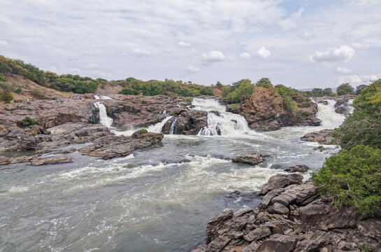  Aerial view of the Kaveri river, rapid streams, cascading waterfalls, shivanasamudra, rocky terrain in the picturesque landscape of Western ghats, India.