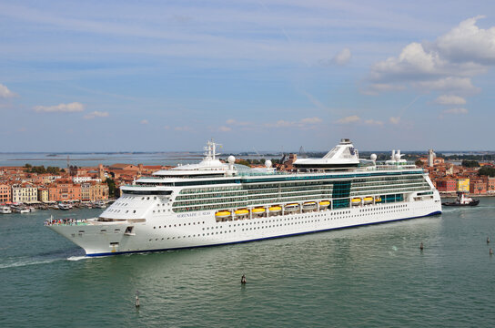 Venice, Italy- Sept 24, 2014: The cruise ship Serenade of the Seas crosses the Venetian Lagoon at morning. More than 10 million tourists visit Venice every year