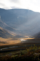 Golden sun rays filling a mountain valley in Sweden, high above the arctic circle on an autumn evening © Jacob Hall