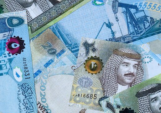 Bahraini dinar money bills in pile on table. Bahrain BHD currency cash close up